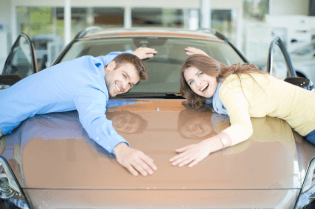 man and woman celebrating car purchase